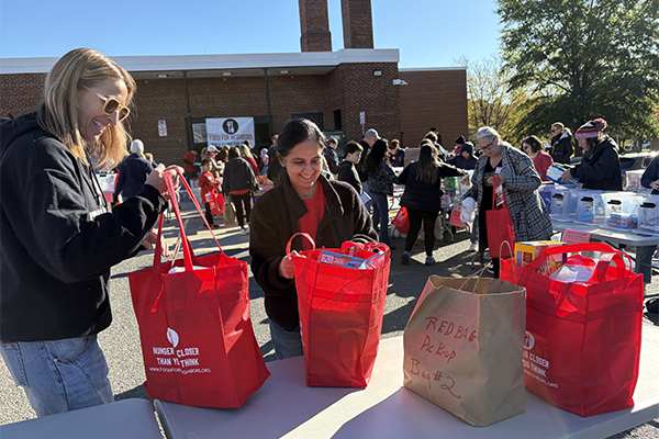 Food for Neighbors volunteers sorting donations at Luther Jackson Middle School