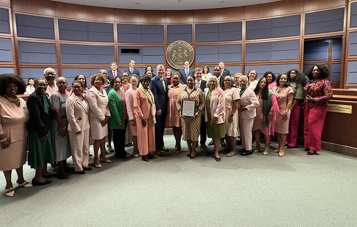 Fairfax County Supervisor Walter Alcorn presents a proclamation to the Alpha Kappa Alpha Lambda Kappa Omega Chapter for their 50th anniversary.