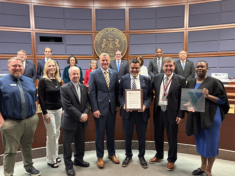 Supervisor Walter Alcorn presents a proclamation to the Reston YMCA for its 25th anniversary