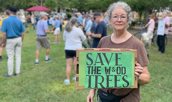 Woman holding a sign that says Save the W&OD Trees
