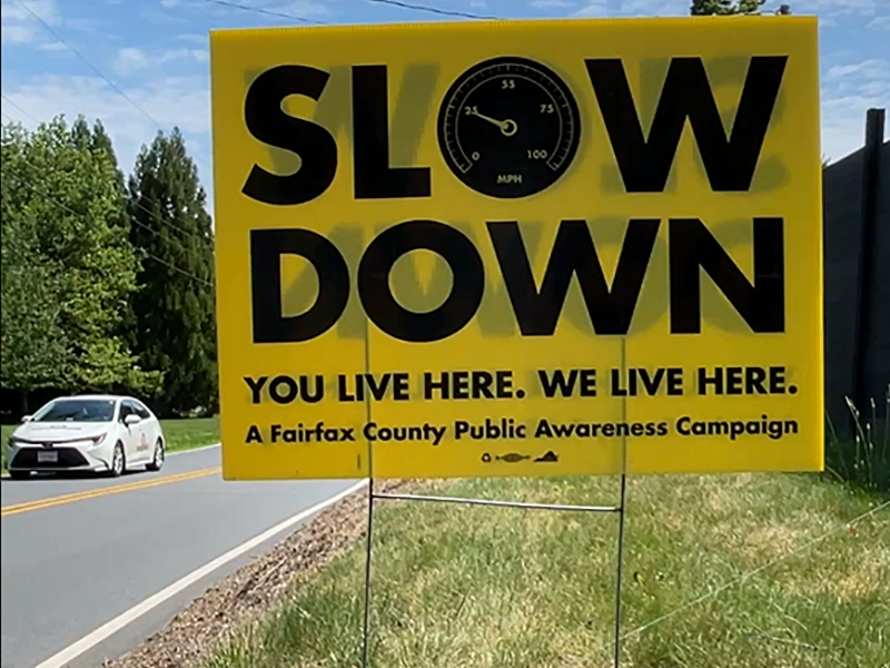 Fairfax County sign that says "Slow Down. You live here. We live here."