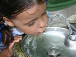 girl drinking from water fountain