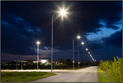 Photo: Street lights illuminating an intersection.