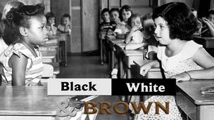 Black-and-white classroom photo of two young girls facing each other at desks with the words “Black White & Brown” overlaid.