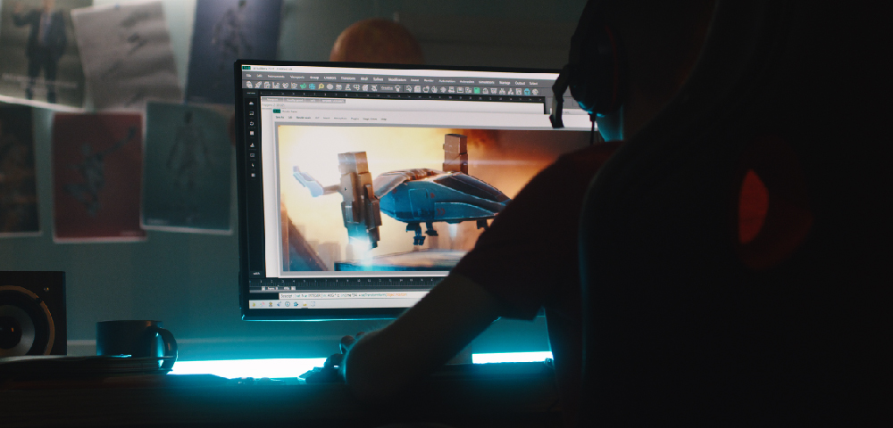 photo of a person sitting at a computer designing a 3D image