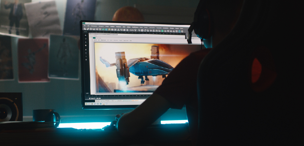 photo of a person sitting at a computer designing a 3D image