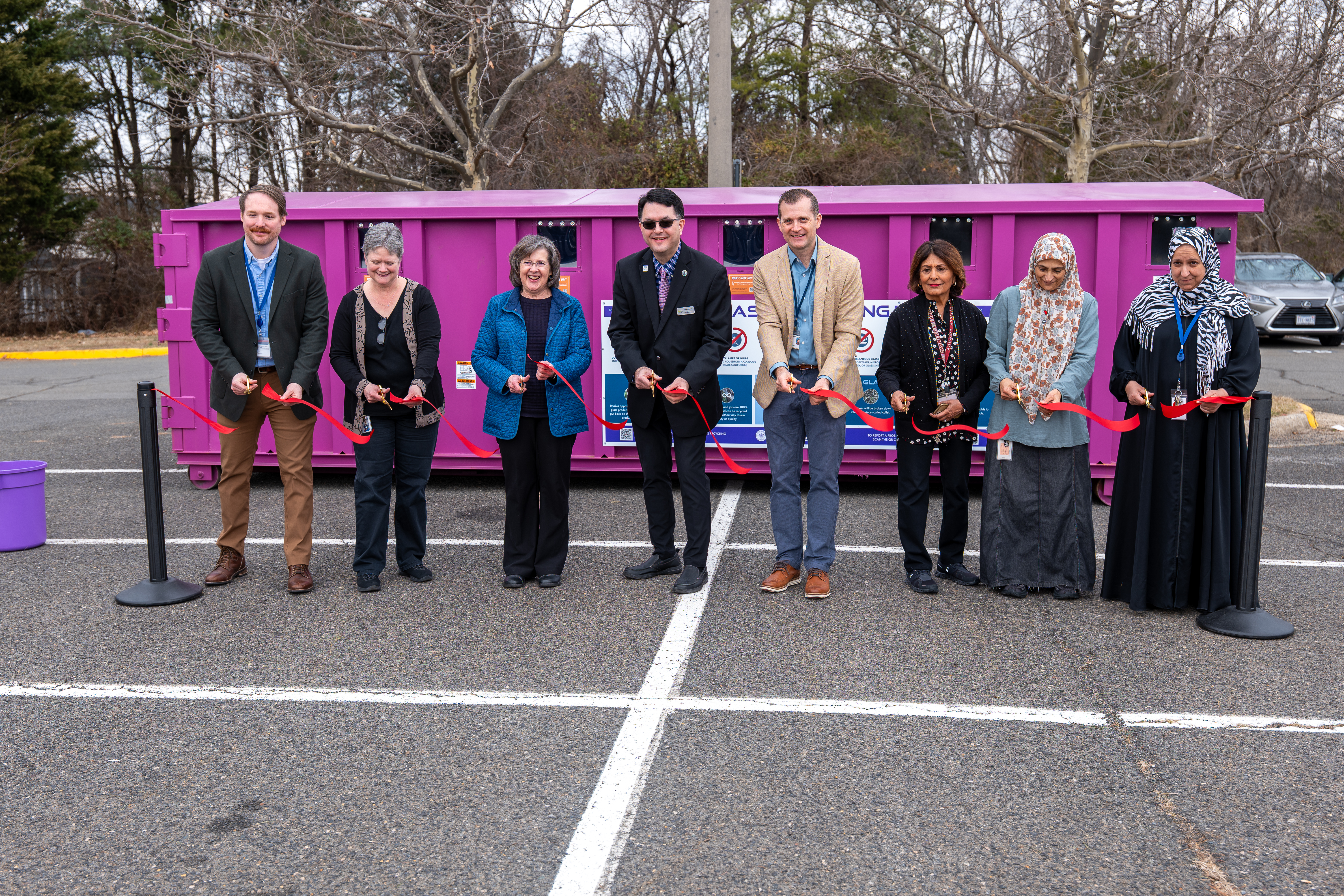 Ribbon cutting for purple glass recycling collection container