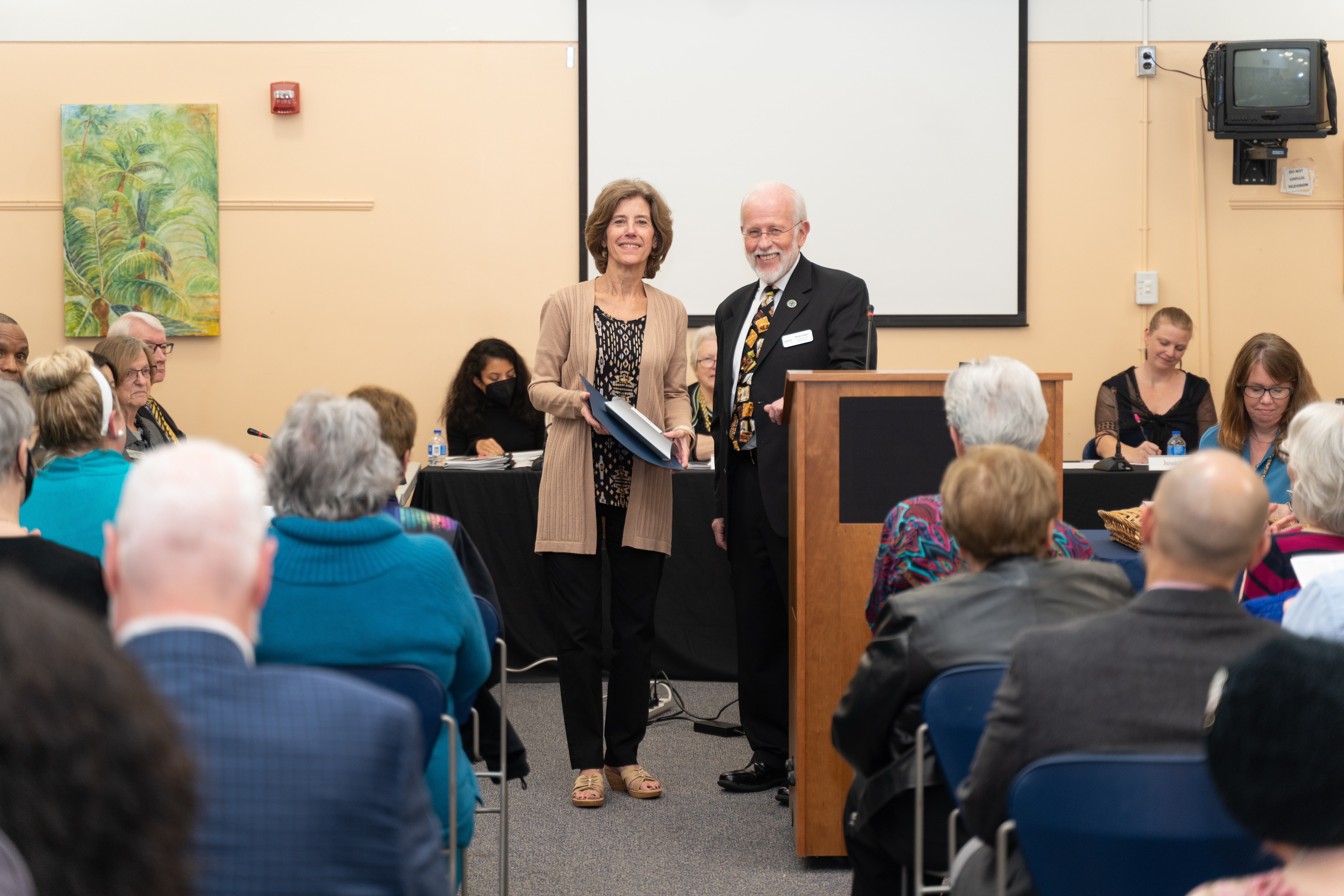 Library Board of Trustees Chair Brian Engler presents Cathy Pluchinsky of the Friends of Centreville Regional Library with an award.