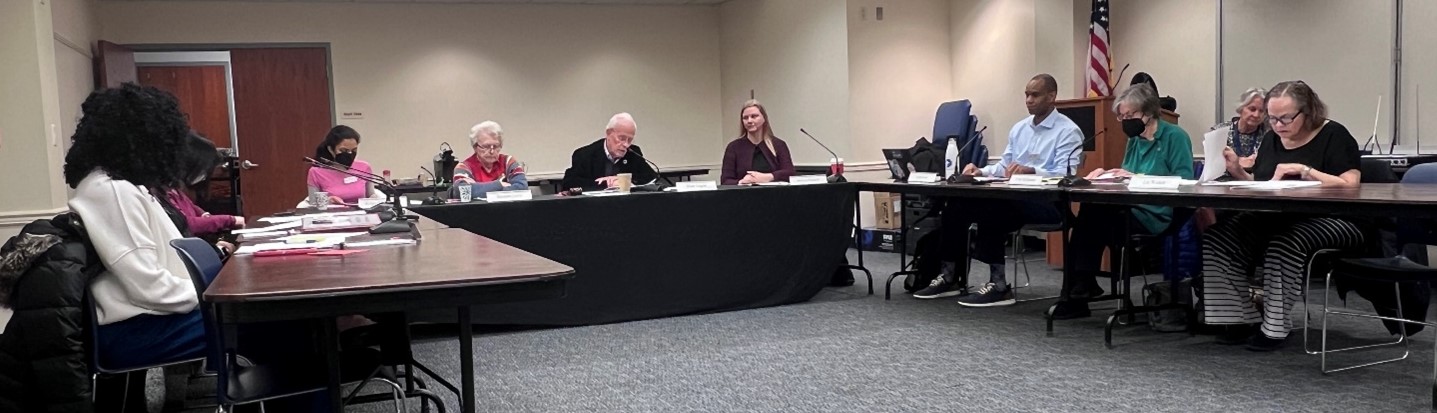 Fairfax County Public Library Board of Trustees members sitting at their table during a meeting on February 14, 2024 