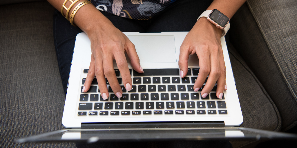 hands typing on a laptop