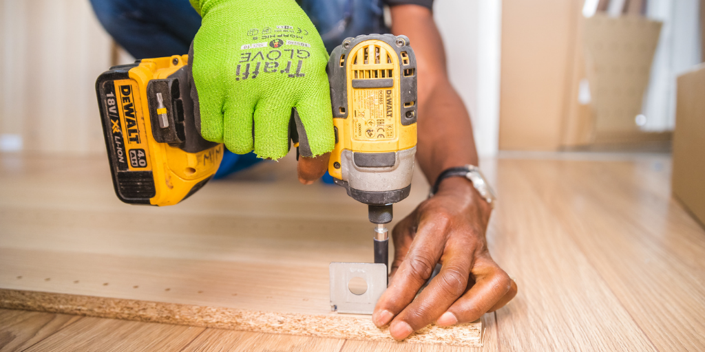 hands using a power tool on wood