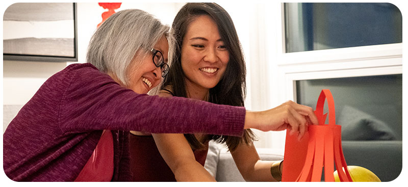 Elderly mother with daughter crafting 