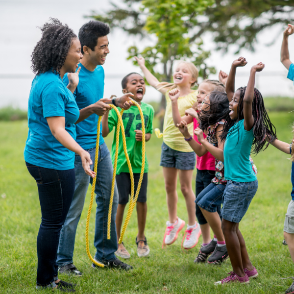 Adults work with children in outdoor environment