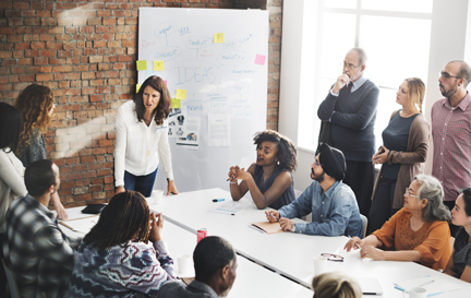 Diverse group of adults participating in a team meeting.