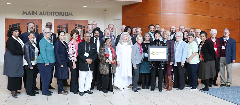 Chairman Bulova surrounded by a large group of interfaith leaders