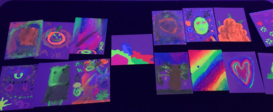 A group of glow in the dark paintings