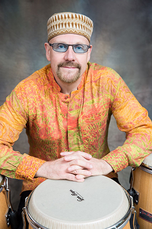 Photo of Tom Teasley with a drum