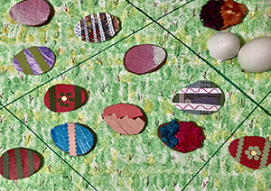 Drawing of a green field with collage drawings of eggs 