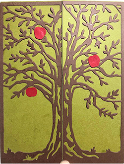 Greeting card featuring an intricate cut paper tree
