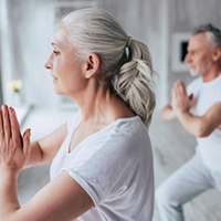 Woman and man practicing yoga