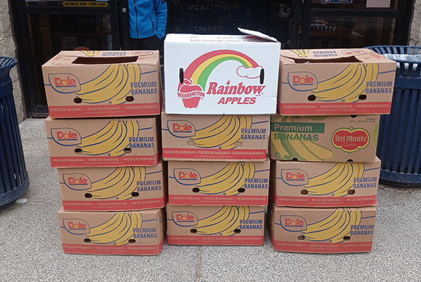 Photo of a stack of fruit boxes. 