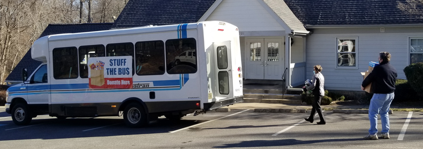 Photos of donors lining up to load the bus at the Commons Community Center.