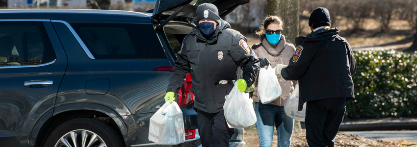 Photo of police officers unloading donations from a car at Pennino.