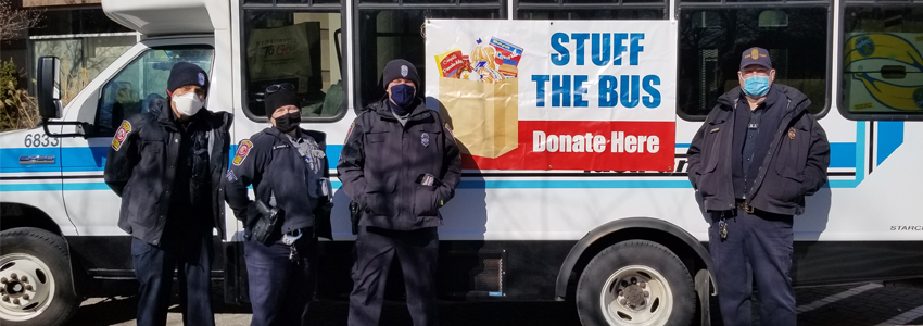 Photo of four FCPD officers in front of the Fastran bus at Pennino