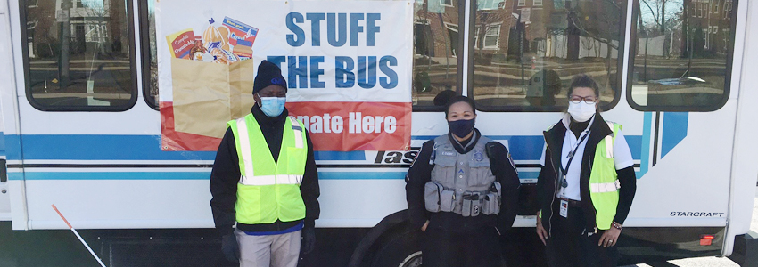 Photo of two Fastran bus personnel and a FCPD officer.