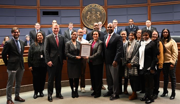 People in Board Auditorium receiving plaque