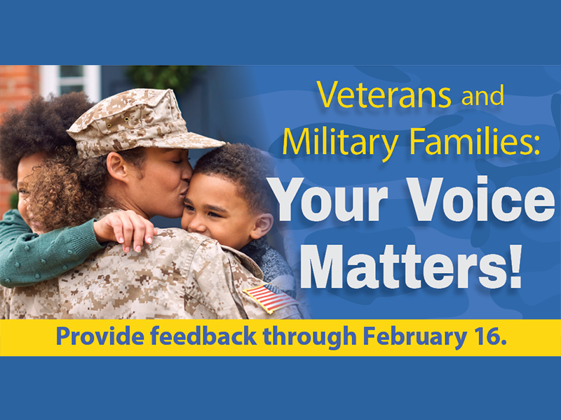 A woman in military dress holding two children.