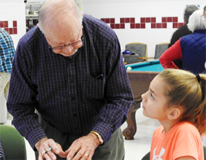 Older adult volunteer with youth.