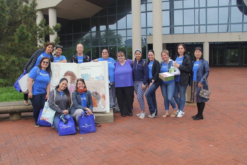 Group of women educators in blue shirts at Fairfax County Government Center 