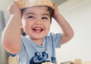 Kid playing with basket on head
