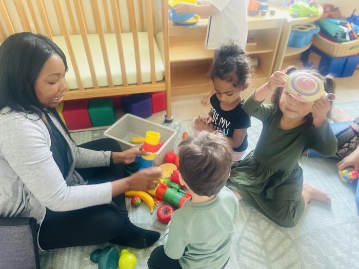 Children and teacher playing  
