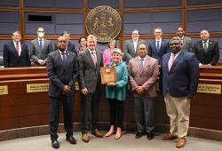 Board of Supervisors members and Reston Community Center's Leila Gordon posing with award.