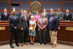 Kim Young and the board pose with her award.