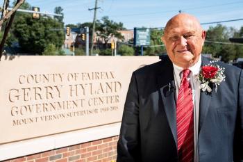 Gerry Hyland with the Hyland Government Center sign.