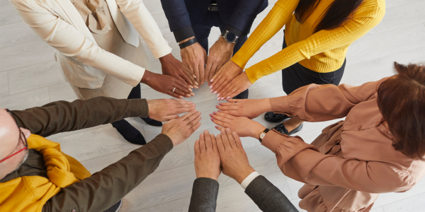 Image of group with hands in center Image of group with hands in center