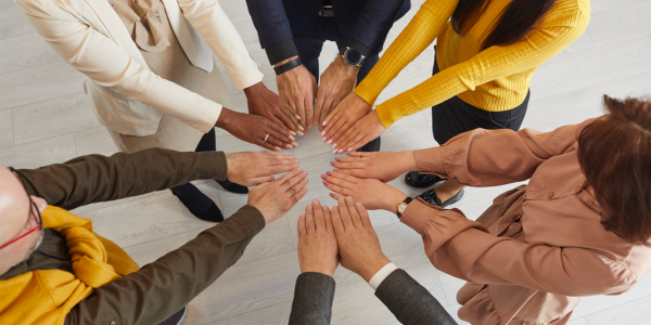 Image of group with hands in center