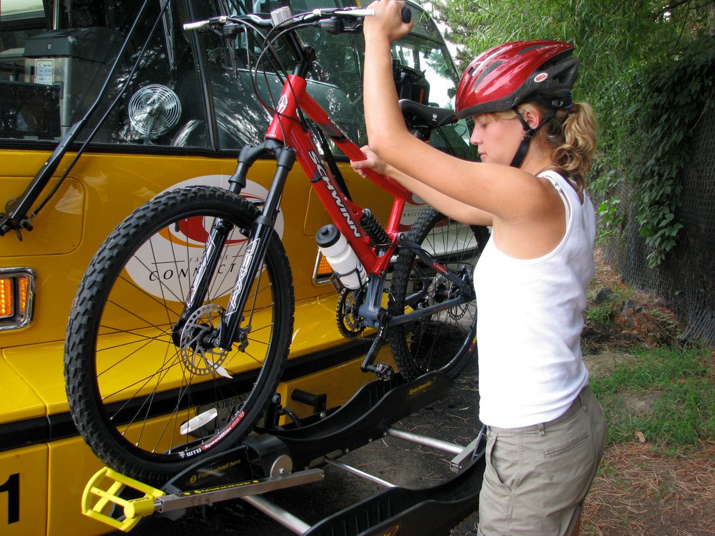 Image of a girl putting her bike on a Connector's bike rack