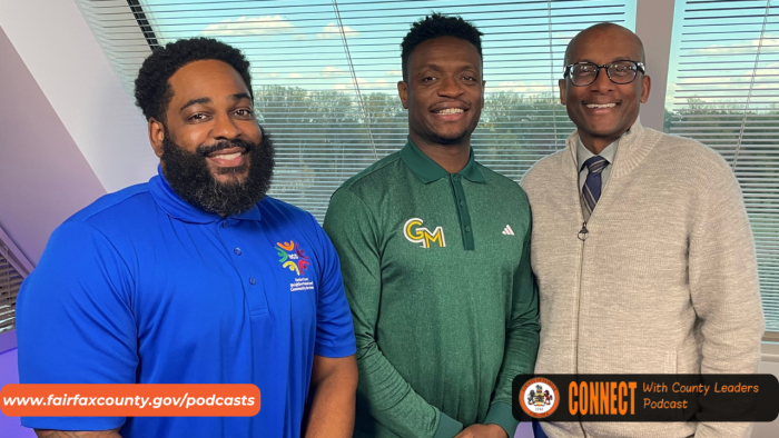 Fairfax County Executive Bryan Hill smiles with Tony Skinn and Terence Trent.