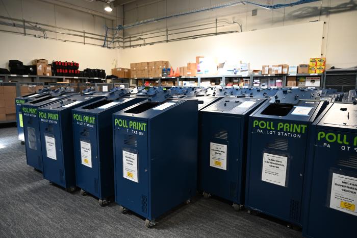 Image of bins holding ballots for different districts. 