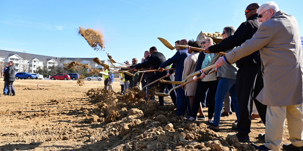 Line of people shovel dirt into the air to celebrate the start of construction for the Franconia Governmental Center and Kingstowne Regional Library. Line of people shovel dirt into the air to celebrate the start of construction for the Franconia Governmental Center and Kingstowne Regional Library.