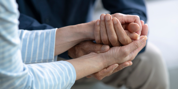 Elderly couple holding hands