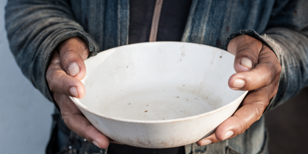 Person who is homeless with empty food bowl Person who is homeless with empty food bowl