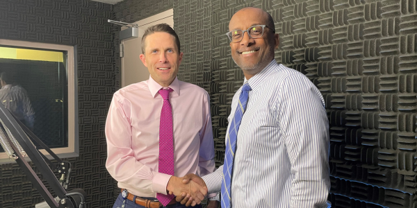 Image of host Bryan Hill, county executive of Fairfax County, shaking hands with Washington Metropolitan Area Transit Authority CEO Randy Clarke