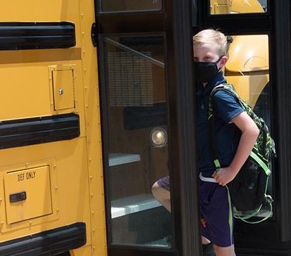 kid getting on Fairfax County school bus