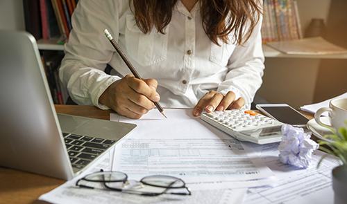 Woman paying her businesses taxes.