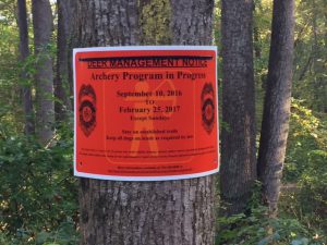 Deer Management Sign on tree